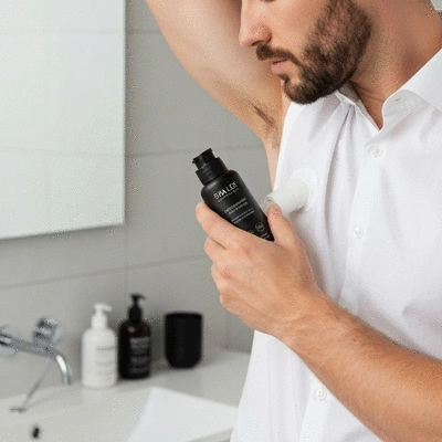 Person spraying freshness spray on a dog's coat